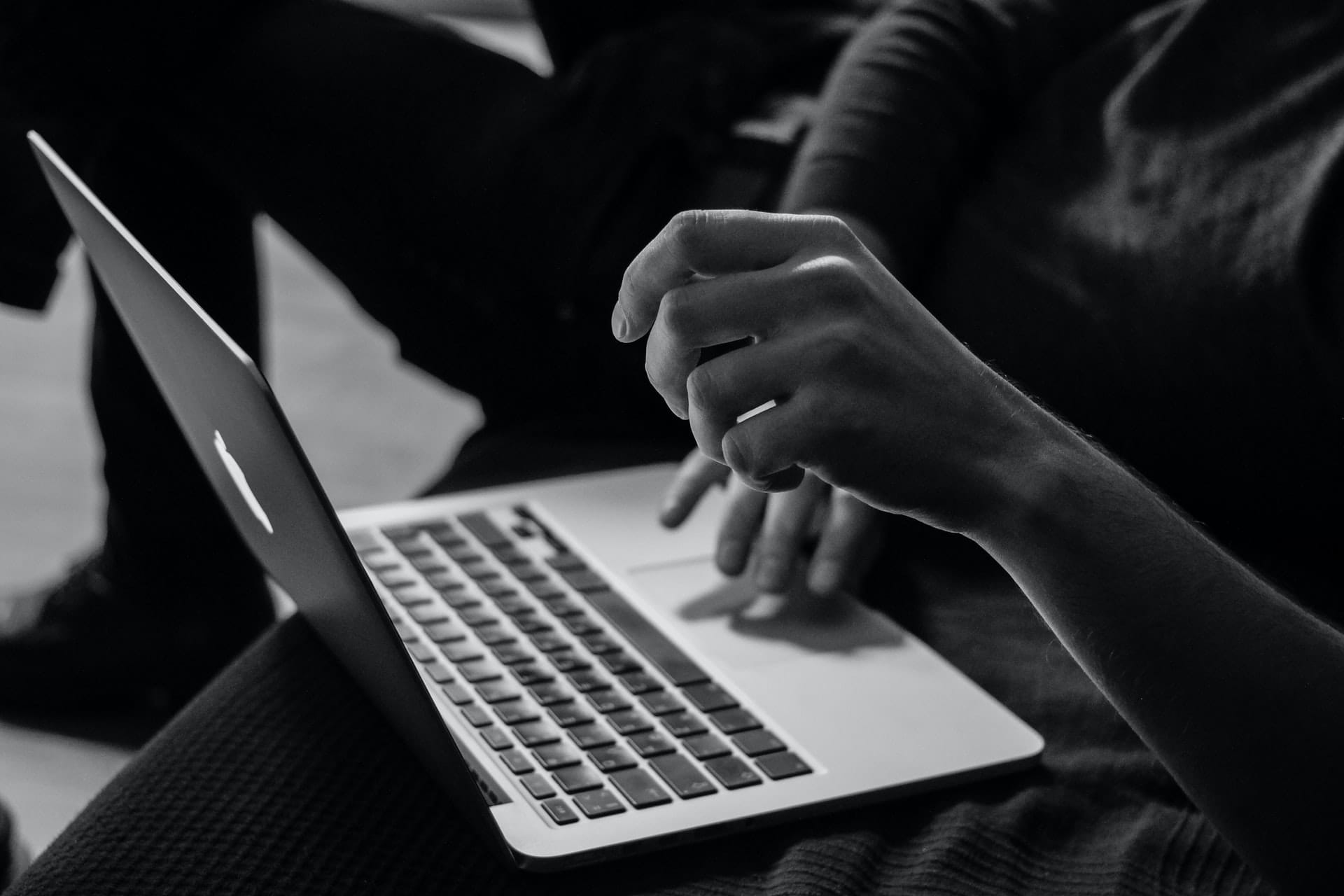 Black and white photograph two people working together.